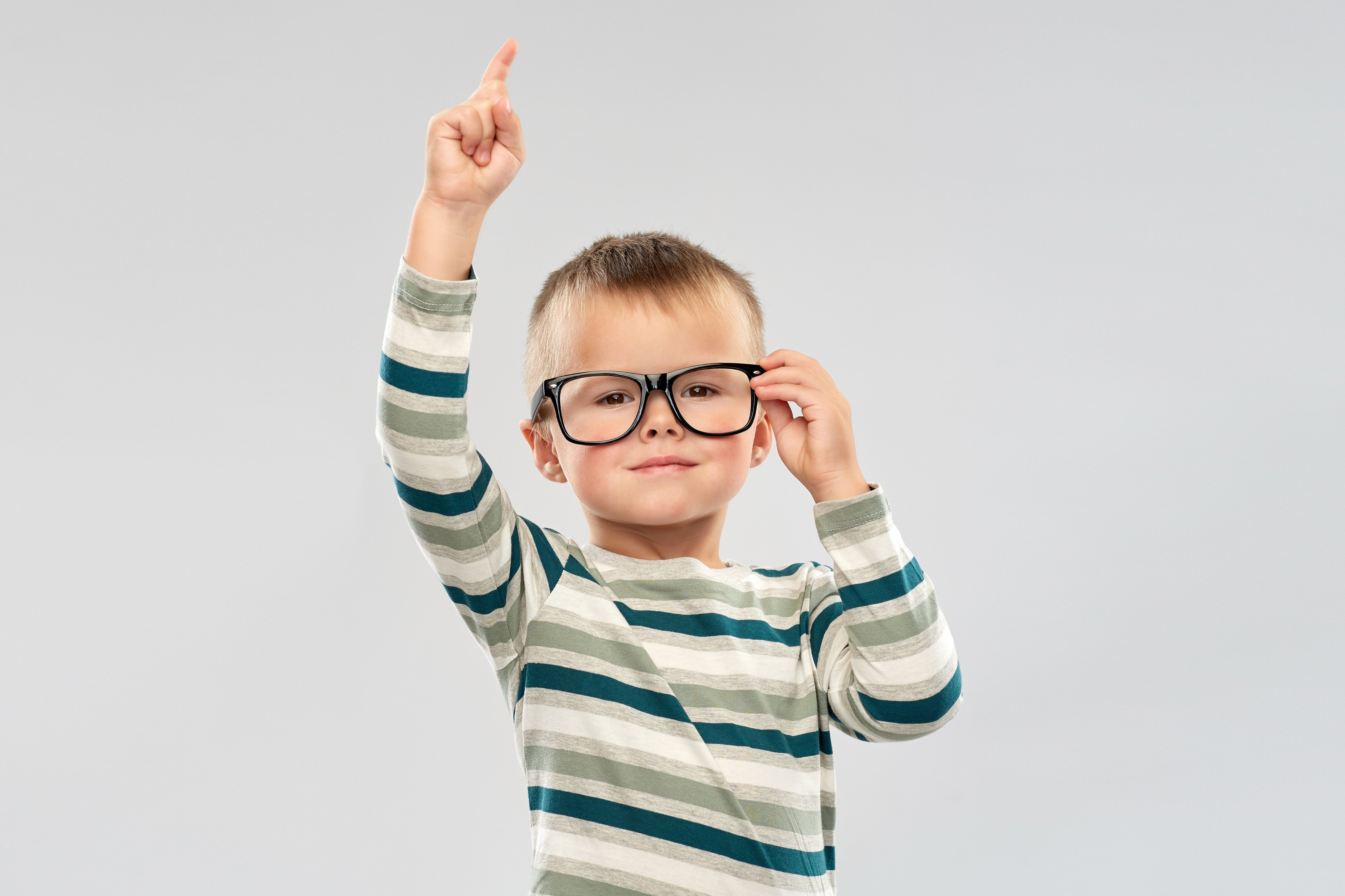 Portrait of Boy in Glasses Pointing Finger Up